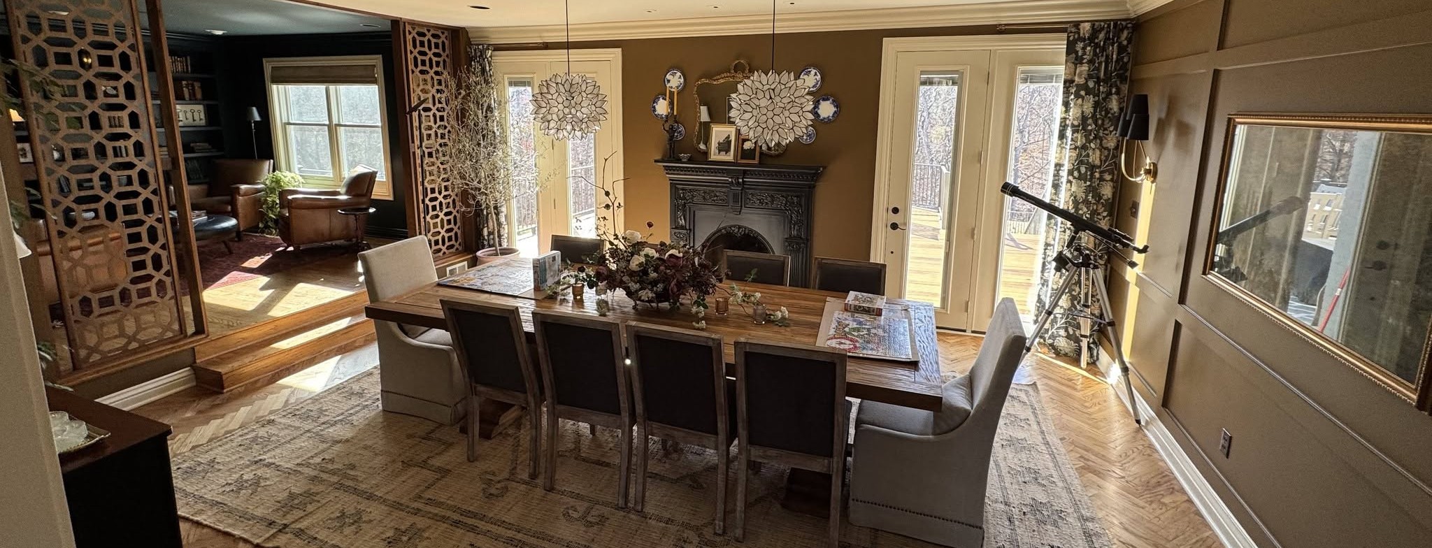 An elegant dining room with herringbone floors and a formal table